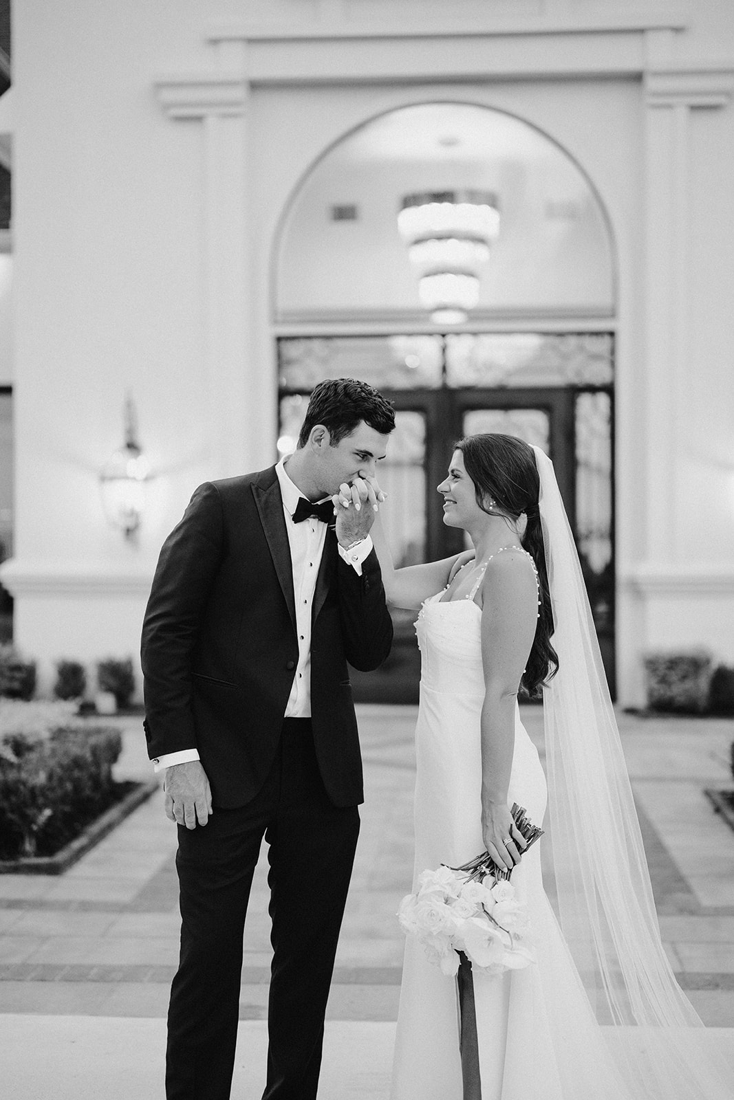 Bride and groom share a quiet moment outdoors, reflecting the personal, elevated experience behind a luxury wedding