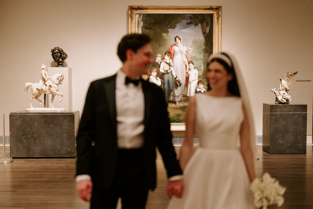 A refined couple walks through the Museum of Fine Arts Houston, blending editorial elegance with personal significance, an example of how luxury weddings can reflect intentional, elevated choices.